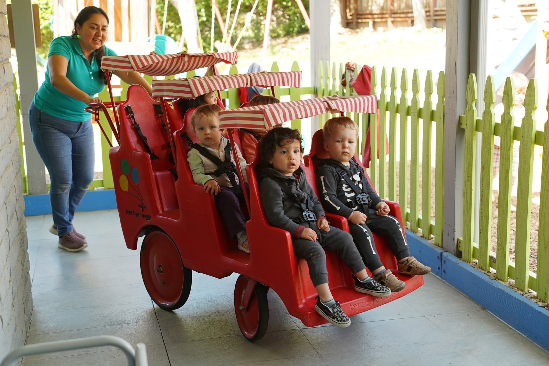 Children playing on the safe outdoor playground at Creative Learners Child Care in Pleasanton, CA. Fun daycare activities.