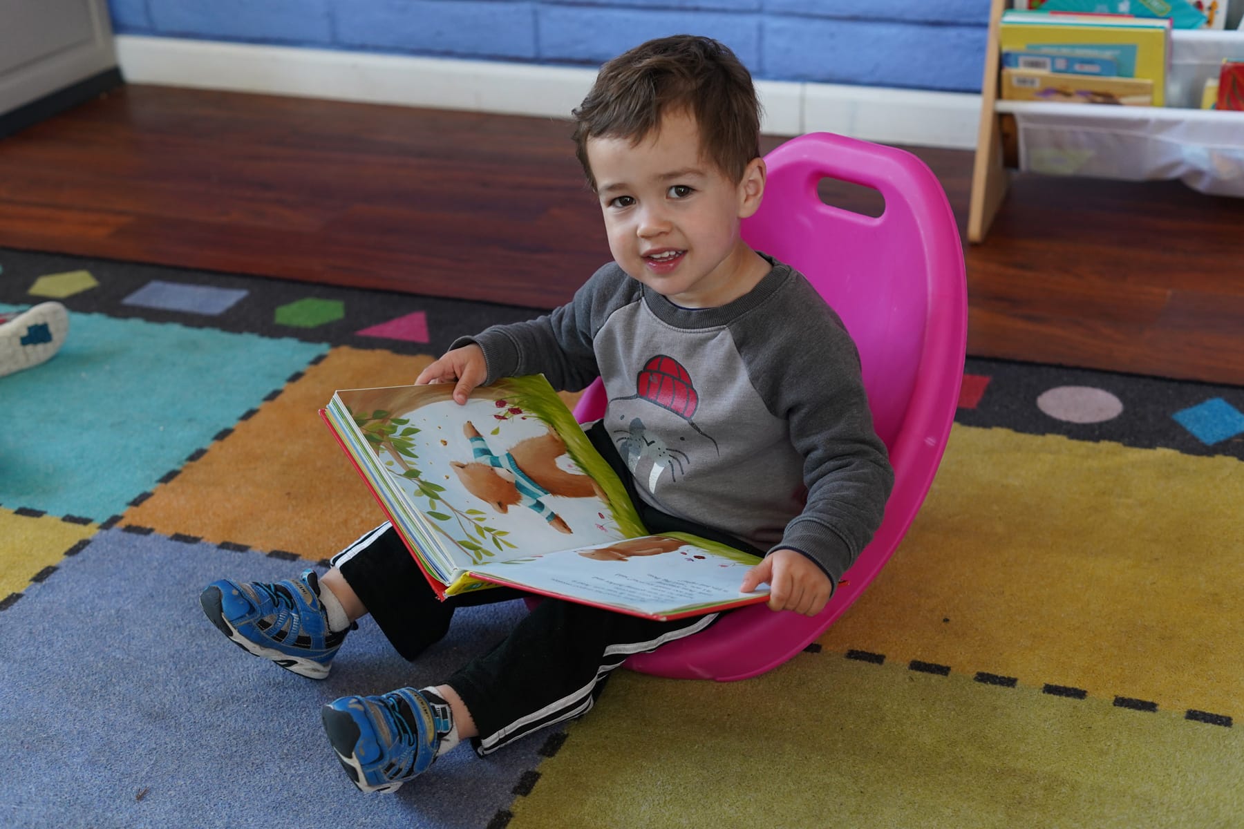 Child reading a book at Creative Learners Preschool in Pleasanton, CA. Quality child care and early education.